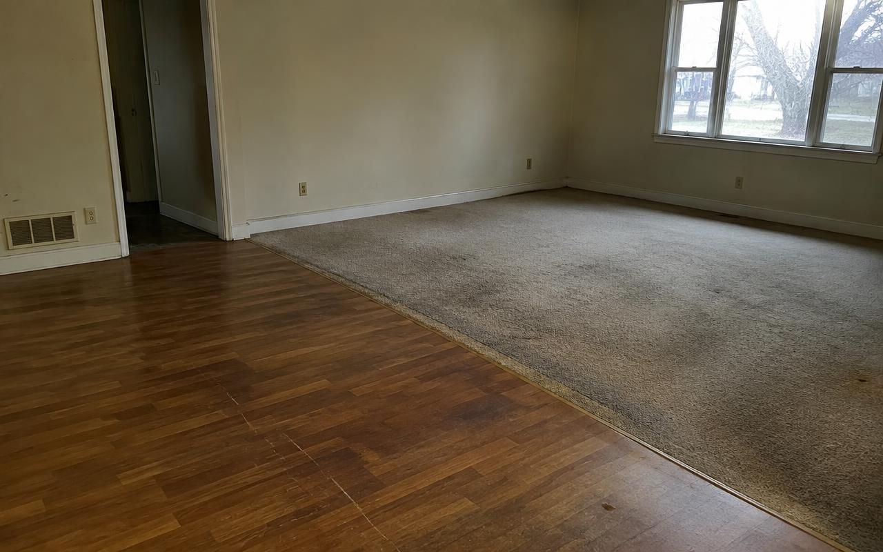 Old carpet and laminate replaced with wide-plank engineered oak flooring — before