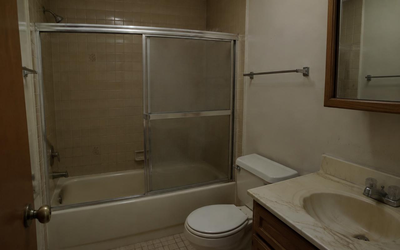 Dated tub bathroom transformed into a curbless walk-in shower — before